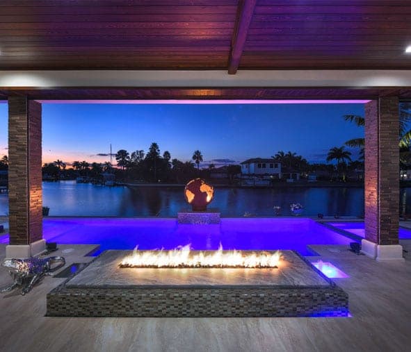 Outdoor fire pit feature — Koogler Homes custom home, Cape Coral, FL